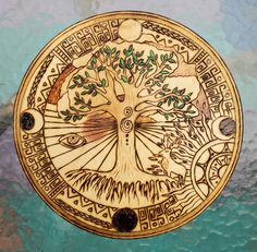 the tree of life is depicted in an intricately designed wooden plate on a blue and green background