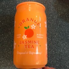 an orange tea can be seen in this hand - held photo, with the label on it