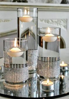 some candles are sitting on a glass table