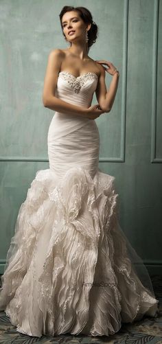 a woman in a white wedding dress posing for a photo with her hand on her hip