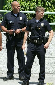 three police officers are talking to each other