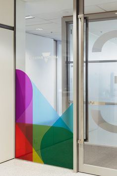 an office door with the letter g painted on it's side and rainbow colors