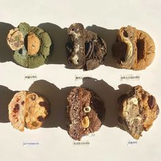 six cookies with different types of toppings on them are arranged in a row and lined up next to each other