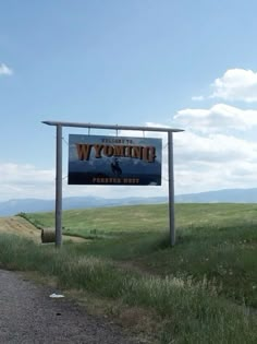 a sign on the side of a road that says wyoming with an image of a man riding a horse