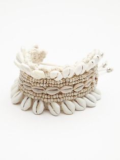 a white bracelet with shells on it