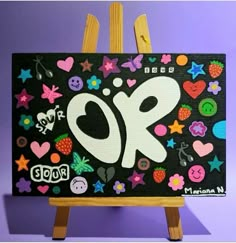 an easel with a painting on it that has the number 90 painted on it