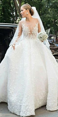 the bride is walking down the street in her wedding dress