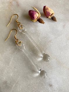 Handmade minimalist clear glass earrings. The earring hooks are made of 14K gold plated stainless steel and are hypoallergenic. They will not tarnish or discolour with time. Including the loop, the earrings are about  6.5 cm long. All earrings are created by melting borosilicate glass rods using a torch and annealed in a digitally controlled kiln for long-lasting durability. Due to the unique nature of this jewellery, earrings will be very similar but not exactly identical. Silver Glass Drop Earrings, Minimalist Glass Drop Earrings, Adjustable Teardrop Glass Earrings, Silver Dangle Glass Earrings, Gold Teardrop Glass Earrings, Minimalist Jewellery, Glass Drop Earrings, Jewellery Earrings, Unique Nature