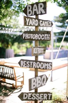 a postcard with several wooden signs on it that read bar yard games, restrooms, bbq dessert