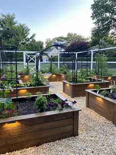 an outdoor garden with raised beds and lights on the sides is featured in this postcard