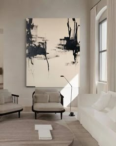 a living room filled with furniture and a painting on the wall