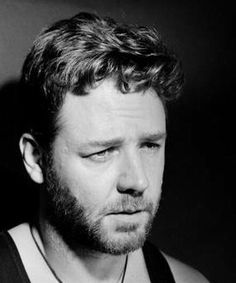 a black and white photo of a man wearing a tank top