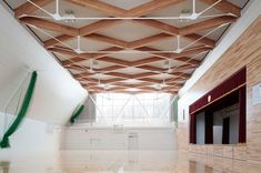 an empty gym with hard wood floors and white walls is seen in this image from the inside