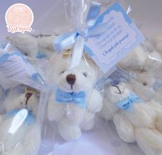 small white teddy bears wrapped in clear cellophane with blue ribbon and tags on them