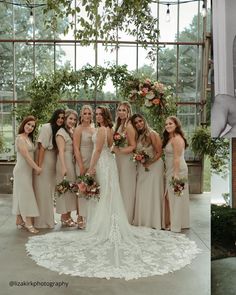 the bride and her bridal party are posing for pictures