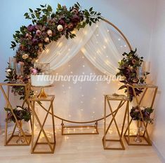 a wedding arch decorated with flowers and candles