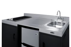 a stainless steel kitchen sink with black cabinets and drawers on both sides, under a faucet