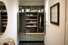 a walk in closet filled with lots of shelves and drawers next to a wall mounted mirror