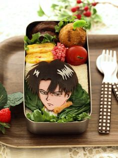 a bento box filled with fruits and vegetables on top of a table next to a fork