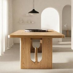 a wooden table with a sink in the center and an arched doorway leading to another room