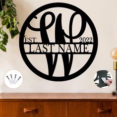 a wall decal with the words last name in a circle on top of a dresser