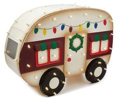 a white and red trailer with christmas lights on it's sides is shown in front of a white background