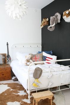 a white bed sitting in a bedroom on top of a hard wood floor