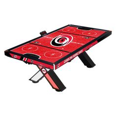 a red and black air hockey table with the atlanta hawks logo on it's side