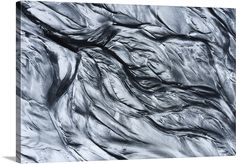 an abstract black and white photograph of water flowing over the rocks in the river bed