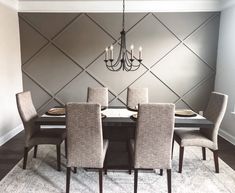 a dining room table with six chairs and a chandelier hanging from the ceiling