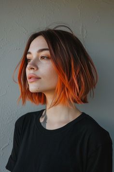 Woman with shoulder-length ombre hair looking contemplatively to the side against a neutral background. Bob Haircut And Color, Short Hair Sassy Styles, Cyberpunk Bob Hair, Two Tone Bob Hairstyles, Bob Alternative Hair, Long In Front Short In Back Haircut, Edgy Bob Haircuts With Bangs, Edgy Long Bob Haircuts, Red Hair Bob With Bangs