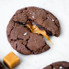 a chocolate cookie with peanut butter on it and one bite taken out of the cookie