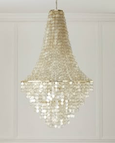 a chandelier hanging from the ceiling in a room with white walls and flooring