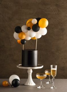 a black and white cake with balloons on top