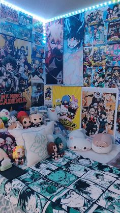 an anime themed bedroom with posters on the wall and stuffed animals sitting on the bed