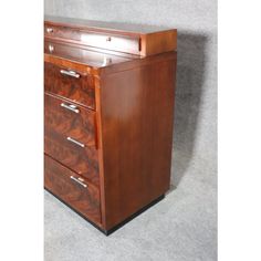 an antique wooden file cabinet with three drawers