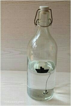 a glass bottle with a boat drawn on the side and a string attached to it