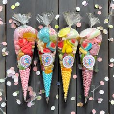 three ice cream cones filled with candy and candies