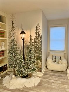 a living room decorated for christmas with white trees and snow on the floor, along with a lamppost