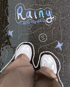 someone is standing on the sidewalk with their feet in the water and writing rain i miss you so much