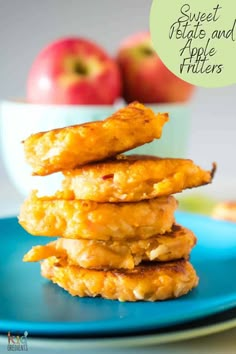 sweet potato fritters are stacked on a blue plate with apples in the background