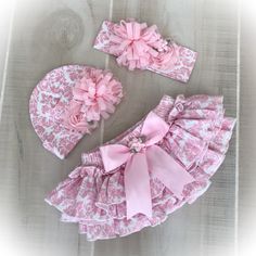 two pieces of clothing with pink flowers and bows