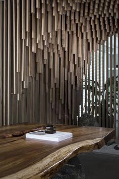 a wooden table with a cell phone on it and some wood slats in the background