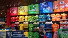 an assortment of t - shirts on display in a store