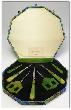 an assortment of green and blue items in a case with two knives on each side