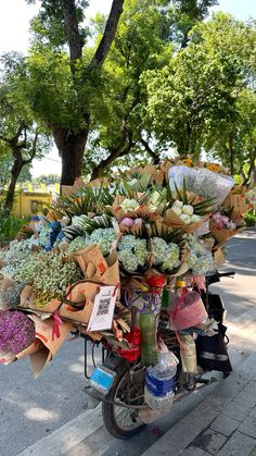 a scooter is loaded with flowers and cards