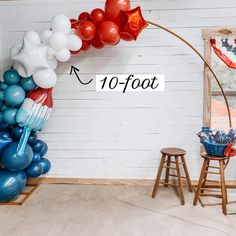 the balloon arch is decorated with red, white and blue balloons