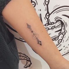 a woman's arm with a tattoo on it that has a clock and stars