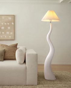 a living room with a white couch and lamp