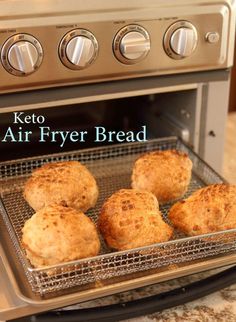 four biscuits cooling in an oven with the words keto air fryer bread above them